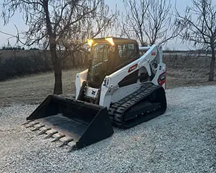 Bobcat track loader on top of gravel driveway