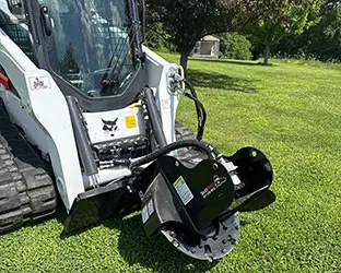 Bobcat track loader with stump grinding attachment